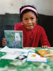 A sponsored child with letters from her sponsor